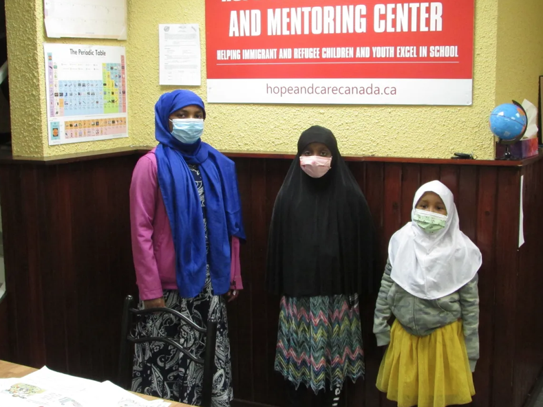 Three students standing together at the tutoring and mentoring centre