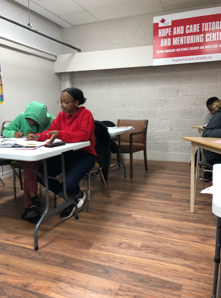 Volunteer tutor helping a student with written schoolwork